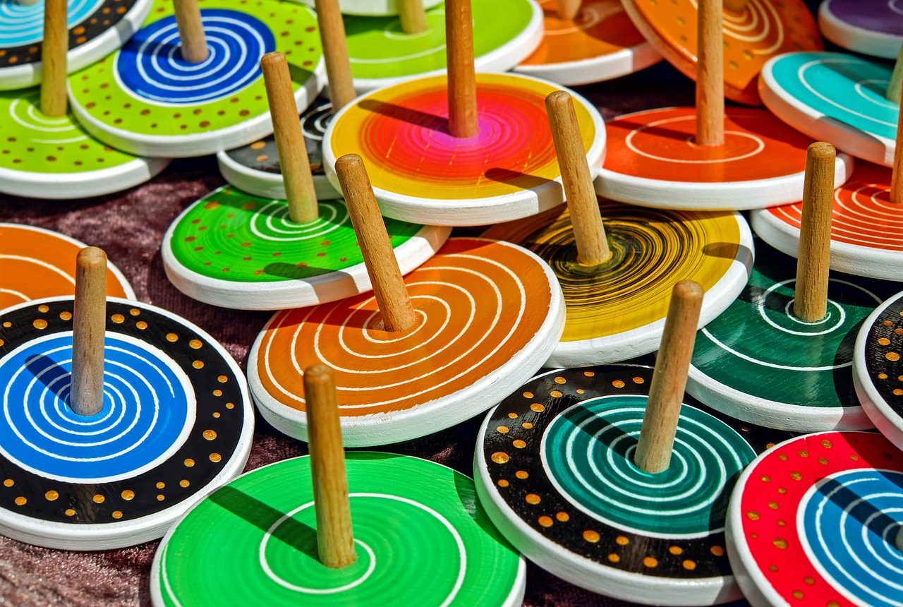 Many colorfull wooden tops each with different design
